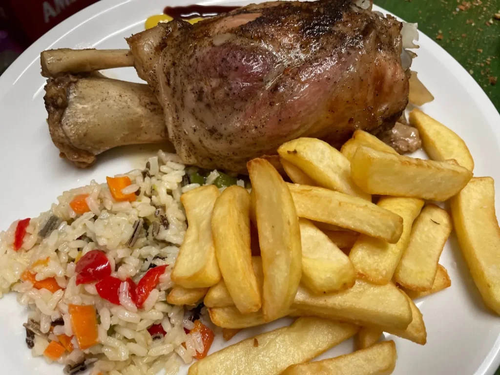 Roast pork knuckle with fries at the Zygos meze restaurant in Aigio