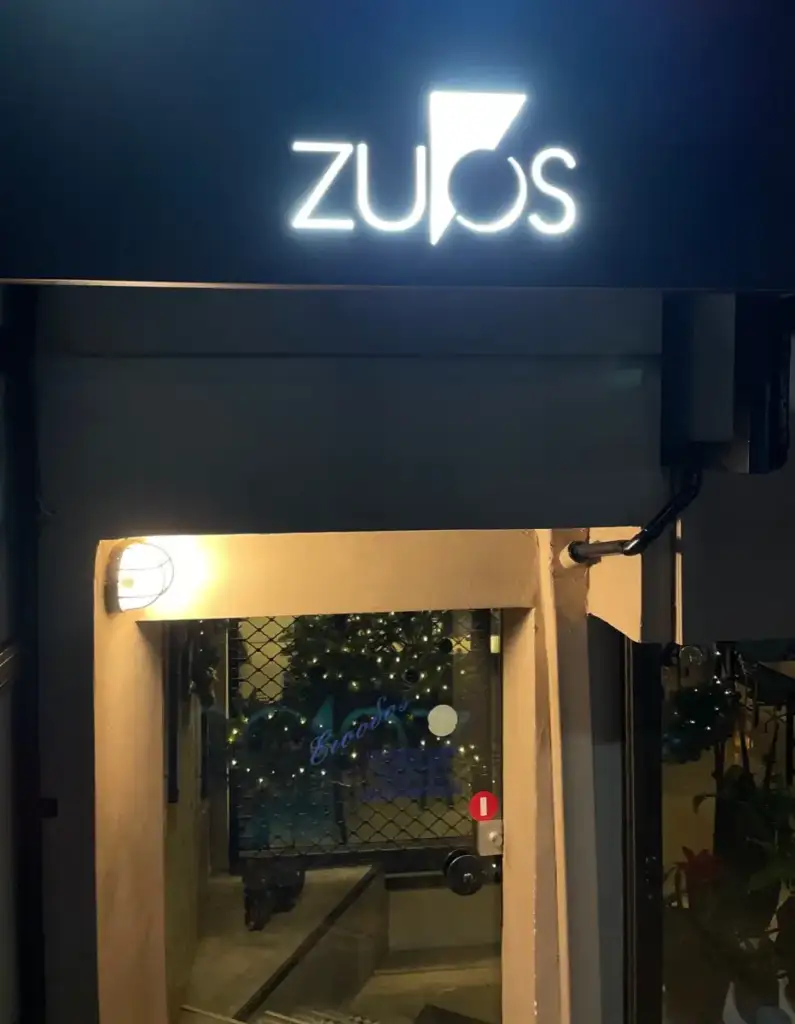 Illuminated Zygos sign at the entrance in Aigio